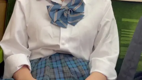 Asian Teen in School Uniform on Train