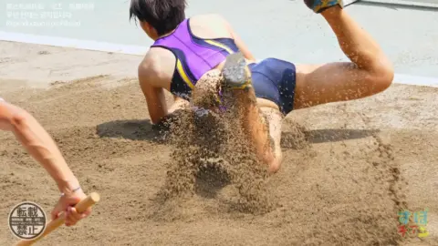 Athletic Asian Performers in Swimsuits at Track and Field
