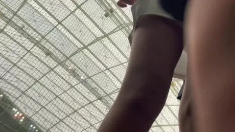 Asian Girl in White Skirt Teases in Sports Arena