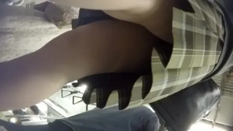 Slim Caucasian Woman Exposes Thighs in Office