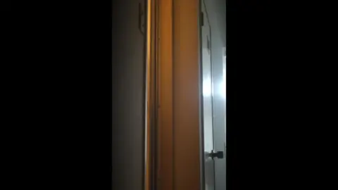 Young Woman Undressing in Bedroom