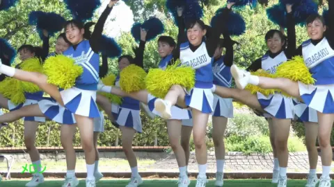 Asian Teen Cheerleaders Outdoor Stage Performance