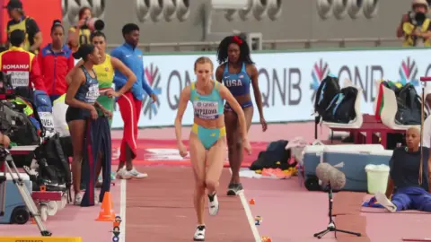 Athletic Women in Sports Attire at Indoor Track
