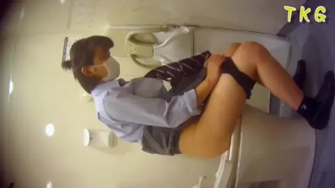 Asian Teen in School Uniform on Toilet