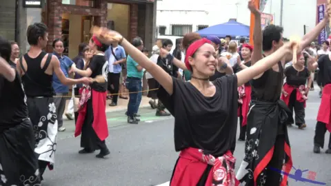 Asian Performers Dancing in the Street