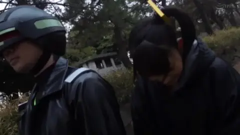 Asian Couple Embraces in Park