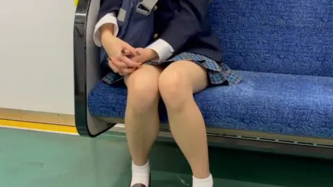 Asian Teen in School Uniform on Train