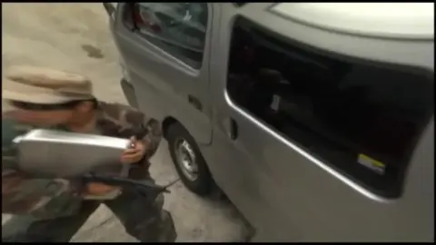 Asian Wrestlers in Costumes Engage in Wrestling Match