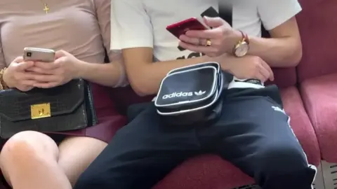 Asian Couple on Couch with Face Masks