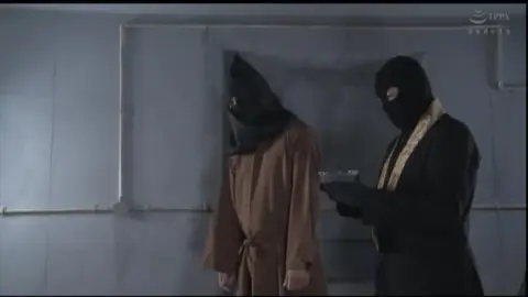 Bound Asian Performer in Red Costume