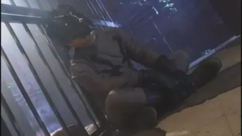 Asian woman restrained and chained in white shirt