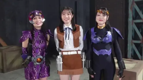 Asian Performers in Costume-Themed Scene