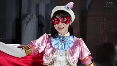 Asian Model in Pink Costume Performs in Industrial Setting