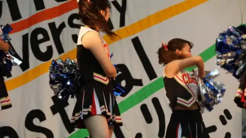 Asian Teen Cheerleaders Perform on Stage