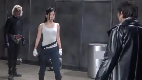 Dark Haired Woman Fights in Industrial Setting