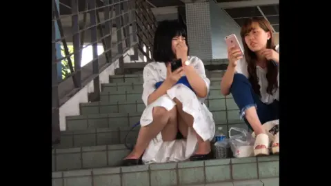 Asian Lesbians Kissing on Staircase