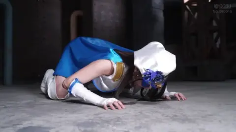 Asian Girl in Costume with Males in Suits