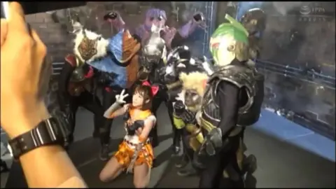 Asian Performers in Costumes Engage in Intimate Scenes