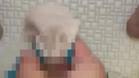 Asian girl waxing in bathroom