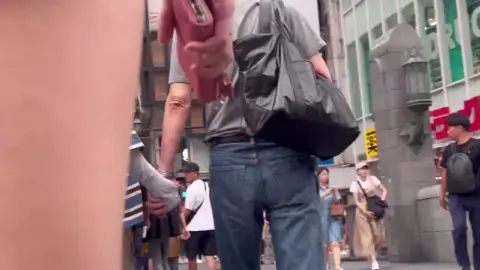 Asian Teen in Black Shorts on the Street