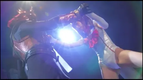 Asian Couple in Costume Engaging in Bondage and Fighting