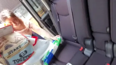 Reaching into Bag and Backseat