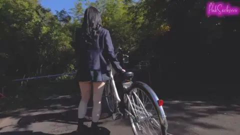 Asian Teen in School Uniform Riding Bicycle