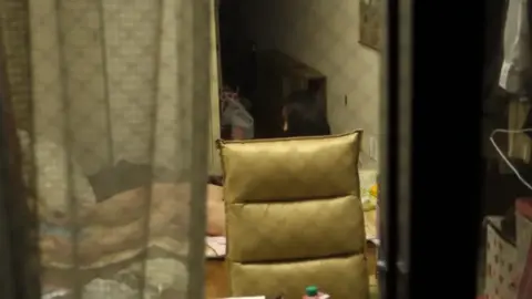 Asian Girl Undressing in Dimly Lit Bedroom