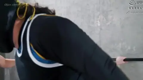 Asian Wrestlers Engage in Intense Grappling Match