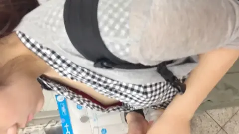 Asian woman shopping, bending over
