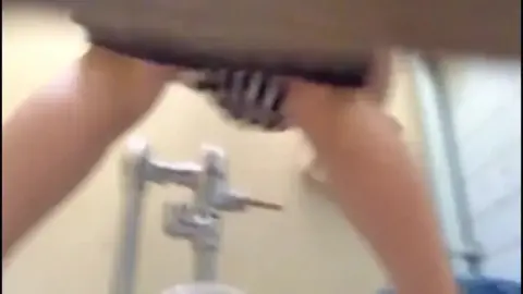 Woman Urinating in Toilet