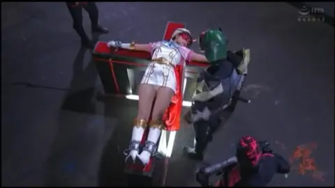 Asian Performers in Costumes Engage in Industrial Setting