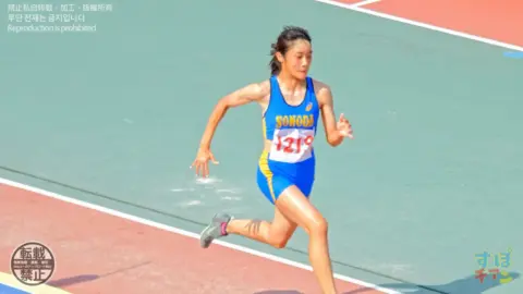 Asian Athletic Girl Running on Track