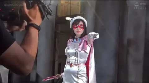 Asian Women in White Dresses and Masks