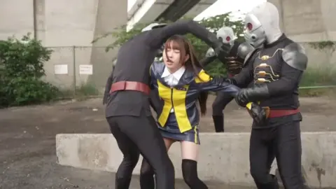 Bound and Hooded Woman in Submissive Pose