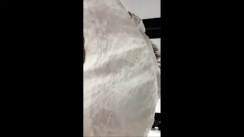 Asian Teen Lays on Bed in Bedroom