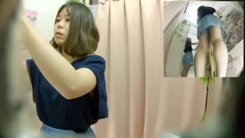 Asian Girl Changing Clothes in Fitting Room