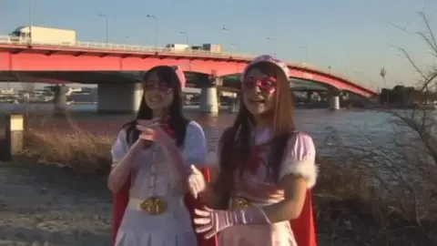 Asian Performers in Cosplay at the Beach