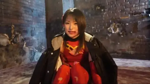 Asian Brunette in Red Bodysuit and Black Jacket