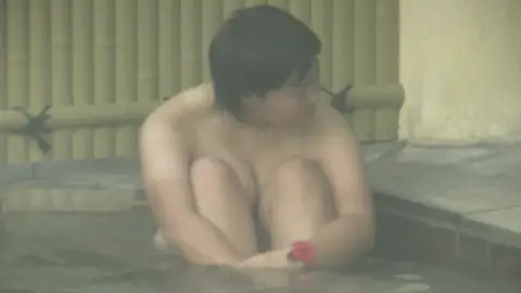 Asian Lesbians Relaxing in Hot Tub