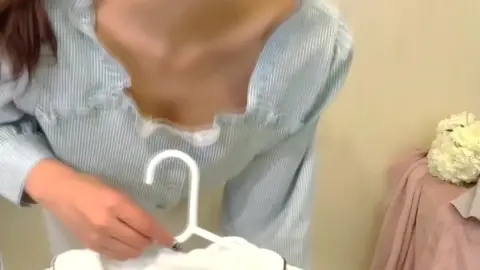 Asian Girl in White Mask Tries On Clothes