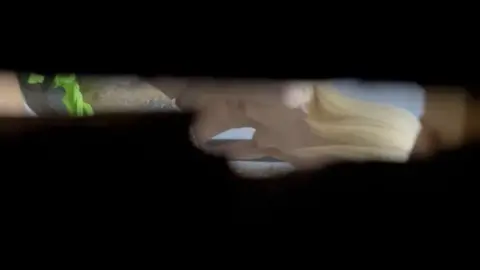 Blonde Masturbates with Sex Toy in Dimly Lit Bathroom