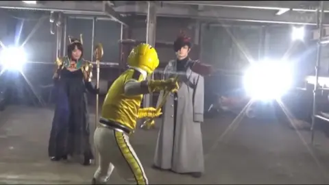 Asian woman in futuristic setting with industrial workers