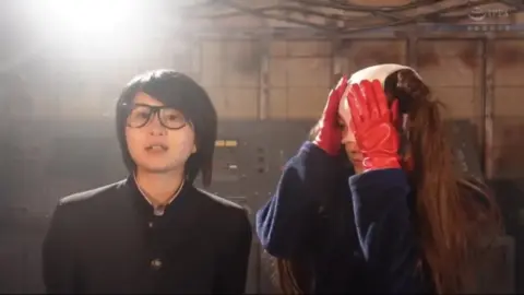 Asian Duo in Industrial Setting