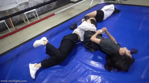 Asian Women Wrestling on Blue Mat
