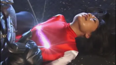 Asian woman in costume receives intimate touch