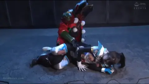 Dark Haired Girl in Armor Costume Struggles