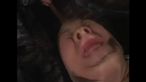 Asian Woman in Pink Bodysuit Restrained and Gagged