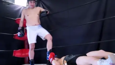 Asian Woman in Boxing Gloves