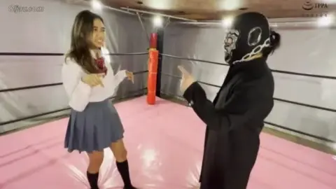 Asian Couple Wrestling and Intimacy on Pink Mat